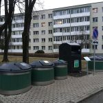 Colour coded recycling bins line a quiet residential street on collection day.